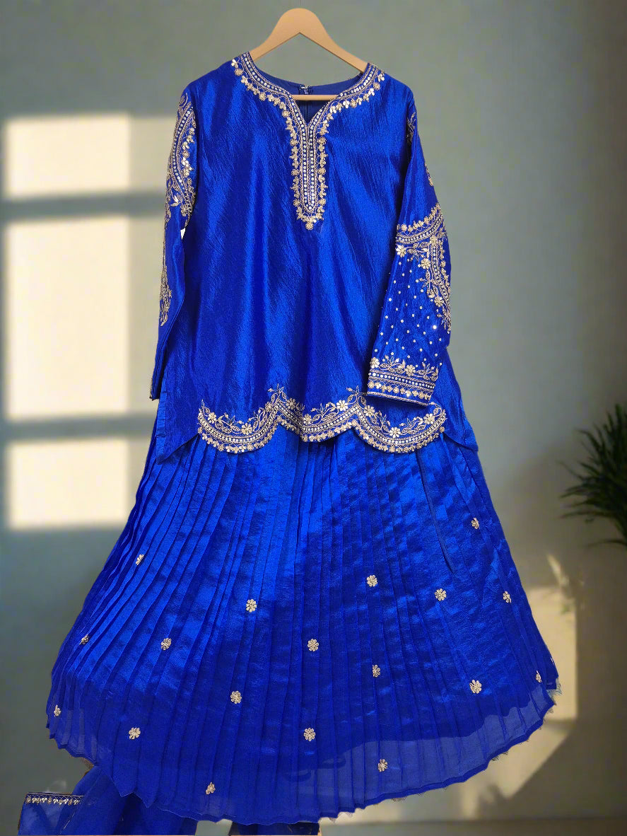 Blue embroidered dress on a hanger against a white background