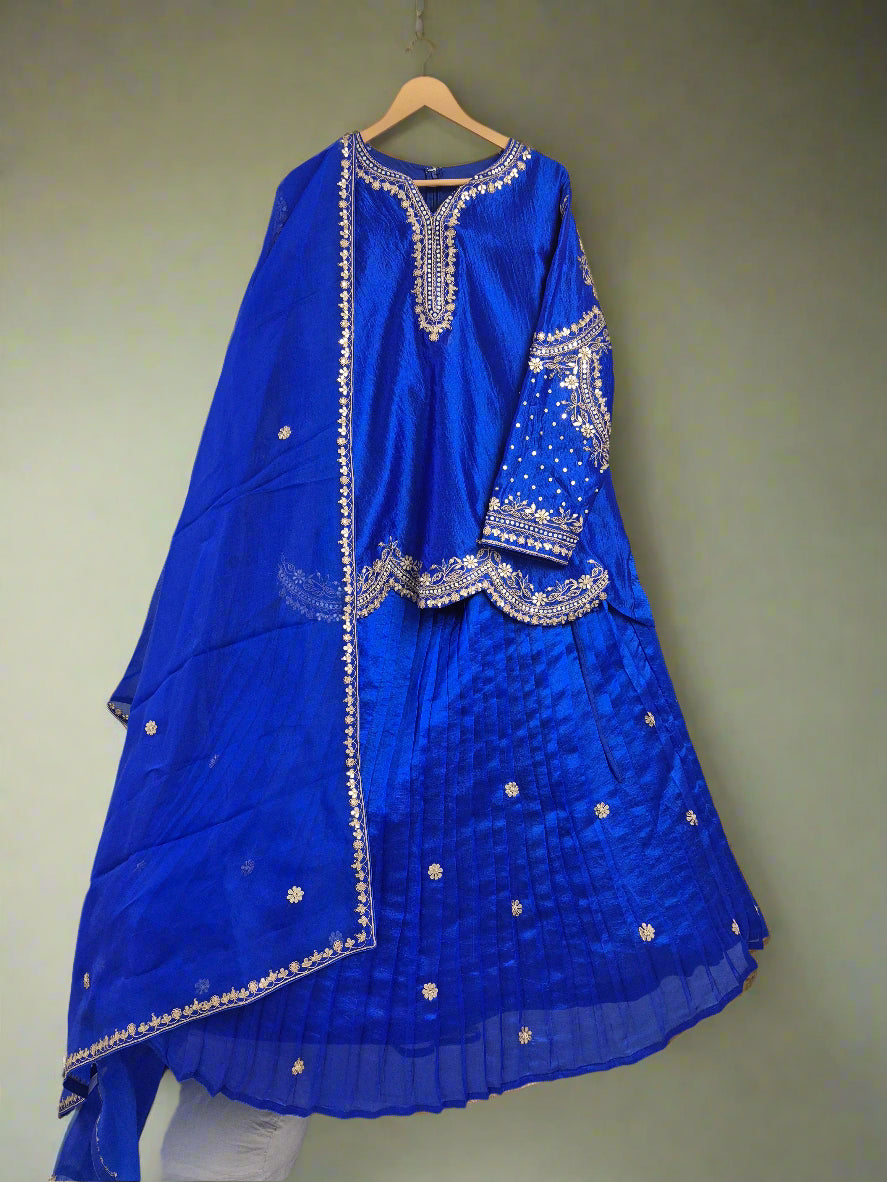 Blue embroidered garment on a hanger against a white background