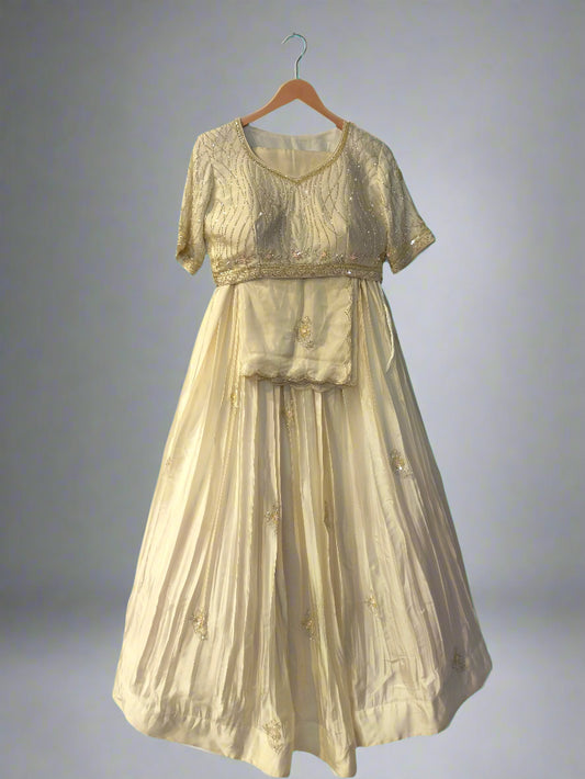 Vintage-style dress on a hanger against a reflective glass wall.