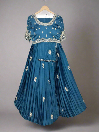 Blue embroidered traditional outfit on a hanger against a neutral background