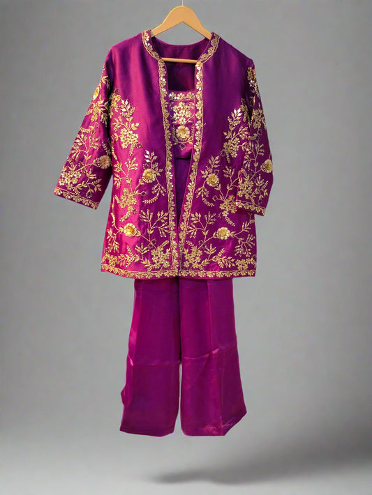 Purple embroidered outfit on a hanger against a neutral background
